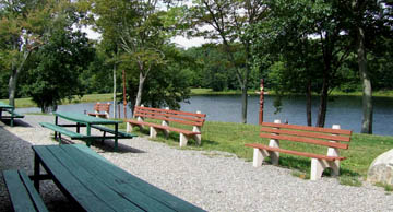 Photo by Leo Taylor
Photo of the outdoor picnic tables and the lake in the rear of the main building.
