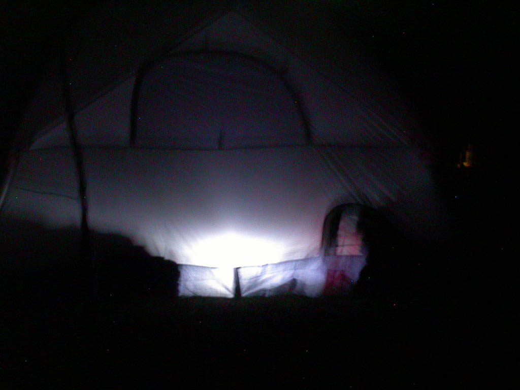 Photo by Ray Kaville
A lone lit tent and the lodge building behind it at a wet CSP 18.
