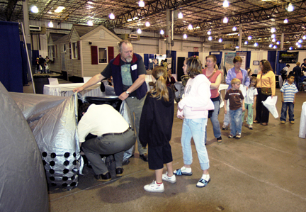 Photo by Alan Chaniewski - CPTV Family Science Expo, April 27-30, 2006
Bob Carruthers helps StarLab participants enter the mobile planetarium. 
