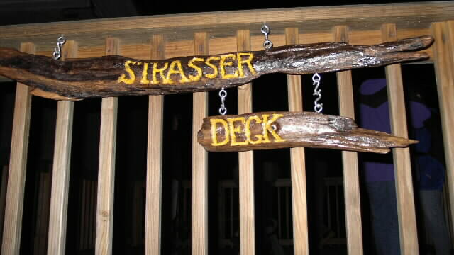 Dedication of the Strasser Deck Photos taken by Eleanor And�jar
The Driftwood sign was made by Bob Carruthers.
The Deck was started with a donation by Pam and Gabe Strasser.
Their objective was to build a Handicap Accessible platform for Stargazing.
The large wood deck has a concrete scope surface and a wooden pier
It is open to ASNH members for stargazing and has been used public viewings.


