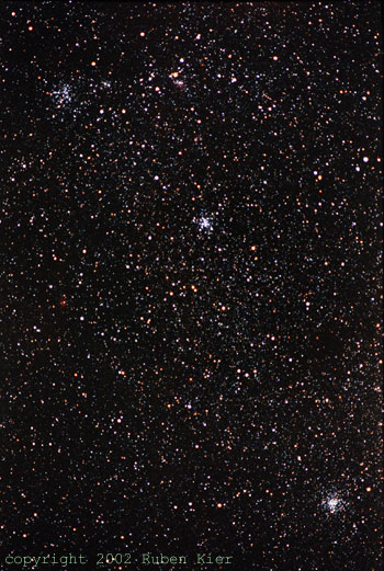 Taken by Ruben Kier 11/22 in New Mexico
M38 (top), M36 (middle), and M37 (bottom) in Auriga
300 mm f/4.5 Pentax telephoto camera lens piggyback,
Kodak 1000 color print film, 20 minute exposure.
