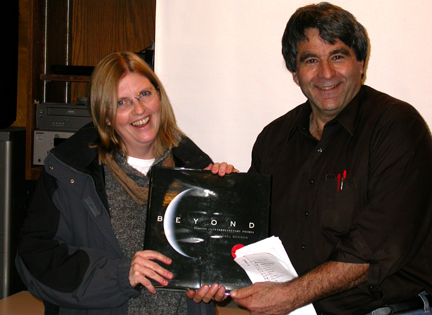 Photo by Ray Kaville
Winter Solstice party 12/13/08 - Al Washburn gives the winner of the quiz the present of a book.
