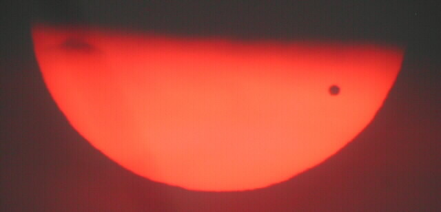  Venus Transit 6/8/2004 by Leo Taylor
Clouds extended from the horizon to about 10 degrees. The first sighting
of the Sun was 10 minutes after dawn when it peeked through the clouds.
The haze was so dense you could see Venus naked eye, and I snapped this
shot without a filter. The clouds completely covered the Sun seconds later,
but we wery happy to have these few minutes of visibility.
5:34 EST, Orion ST-80, CoolPix 850, Scopetronix 16mm, No Solar Filter!


