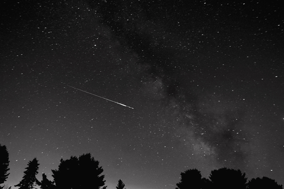 Photo by Alan Chaniewski
A Perseid Meteor rips through the atmosphere into the constellation Sagittarius on August 13, 2007 at 2200hrs. Photo taken from Colchester, Ct. with a Canon 20d modified camera, with a Nikon 14mm lens, at a 1 min. 30 sec. exposure, at 800 iso. 
